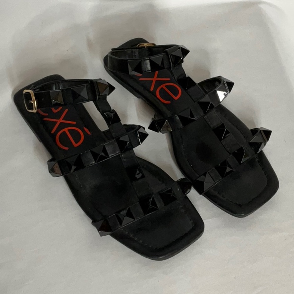 Exe’ Black Studded Ankle Strap Flat Sandals